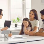 a family seeking advice on health insurance from a doctor