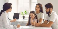 a family seeking advice on health insurance from a doctor