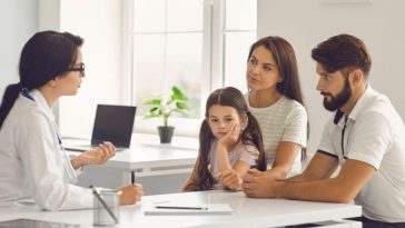 a family seeking advice on health insurance from a doctor